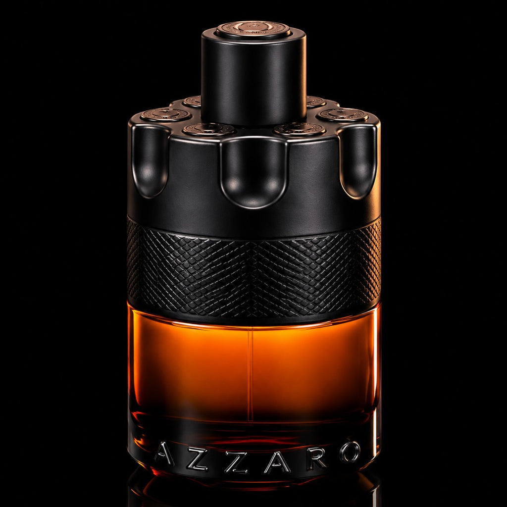 decantME Azzaro The Most Wanted Parfum in a revolver-style glass bottle with amber liquid on a black background